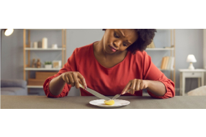 Vrouw eet met moeite een klein stukje voedsel