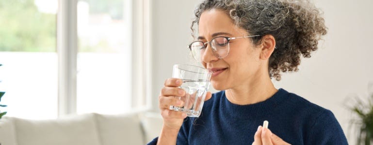 Vrouw neemt een supplement met uridine
