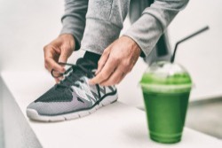 Man stikt veters en neemt een smoothie met moringa Man stikt veters en neemt een smoothie met moringa