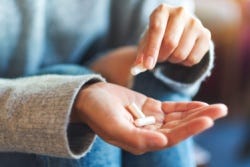 Hand met voedingssupplementen Hand met voedingssupplementen